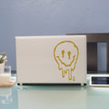 aufkleber-fuer-laptop-schmelzender-smiley-gold
